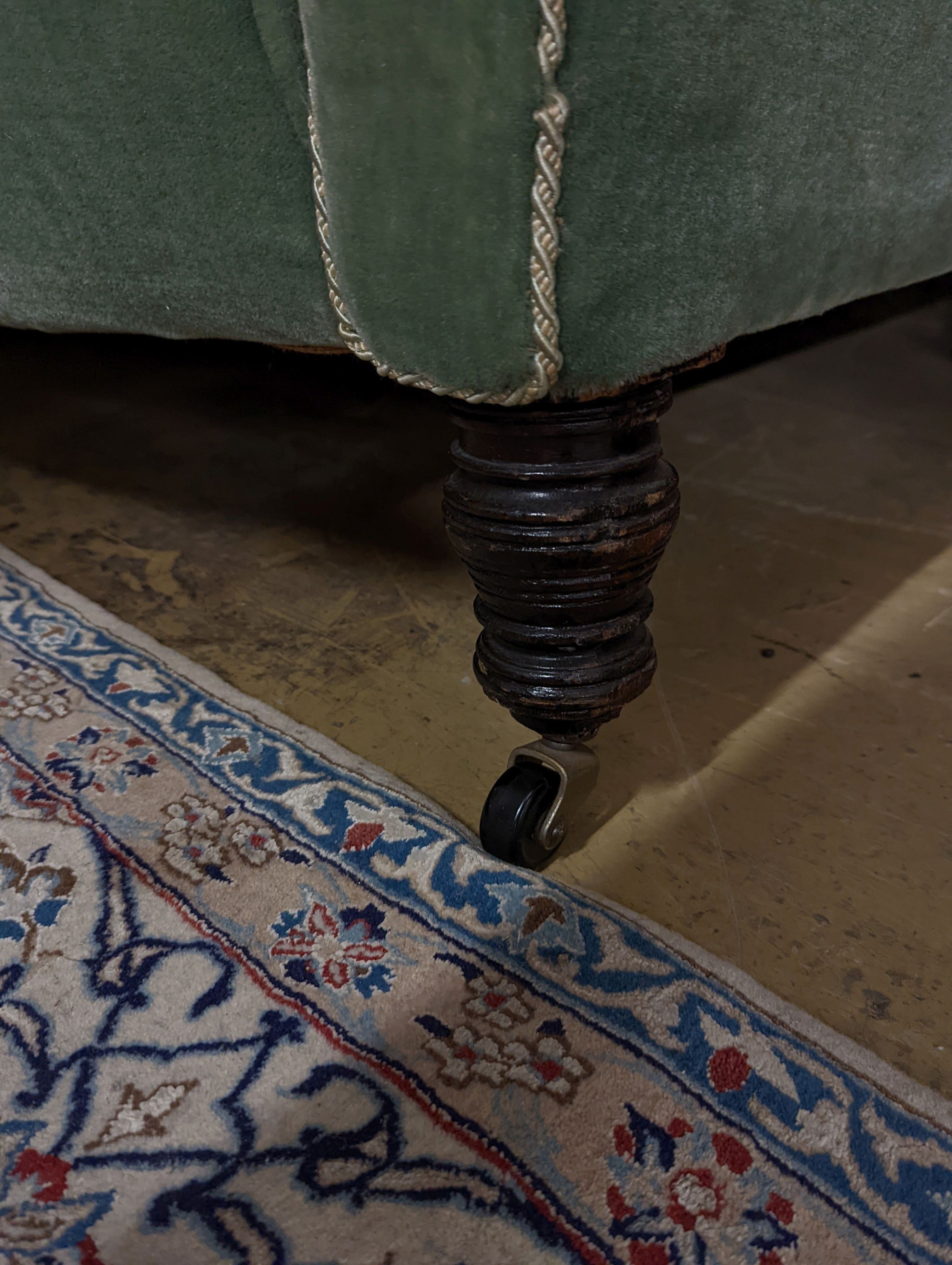 A late Victorian Chesterfield settee upholstered in buttoned green fabric, length 194cm, depth 80cm, height 76cm